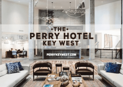 Modern hotel lobby with an industrial chic aesthetic featuring plush seating and a prominent hotel name display.